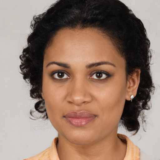 Joyful black young-adult female with medium  brown hair and brown eyes