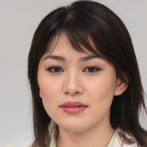 Joyful asian young-adult female with medium  brown hair and brown eyes