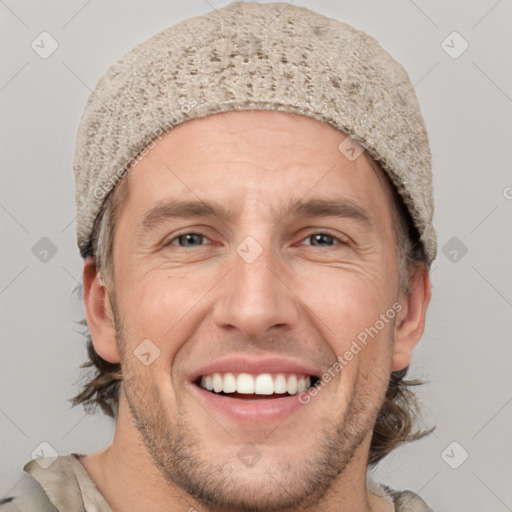 Joyful white adult male with short  brown hair and grey eyes