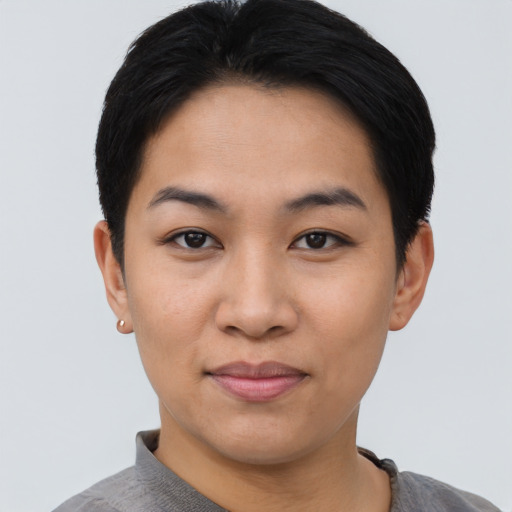 Joyful asian young-adult female with short  black hair and brown eyes