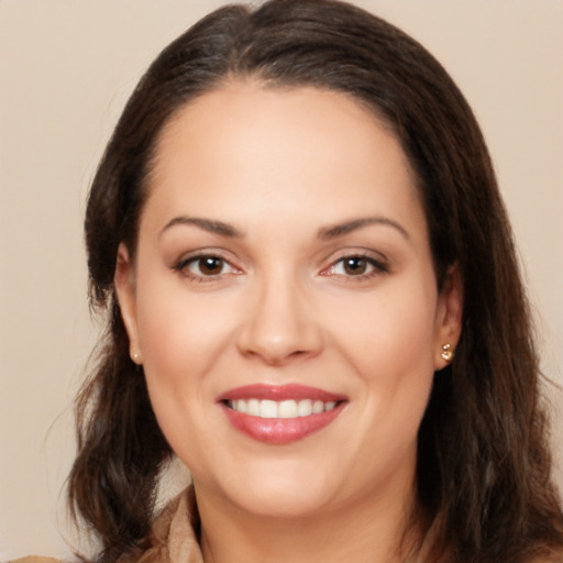 Joyful white young-adult female with long  brown hair and brown eyes