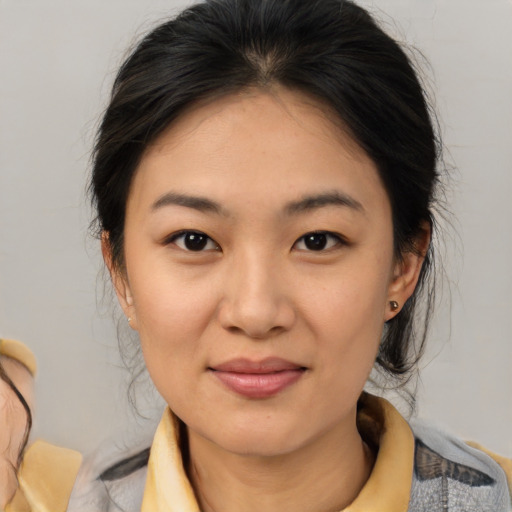 Joyful asian young-adult female with medium  brown hair and brown eyes