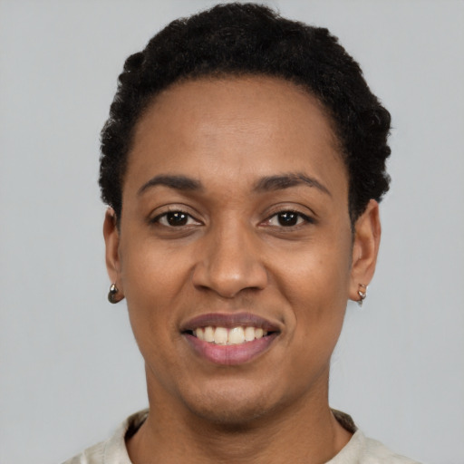 Joyful latino young-adult female with short  black hair and brown eyes