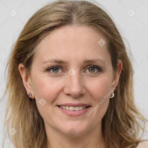 Joyful white adult female with long  brown hair and grey eyes