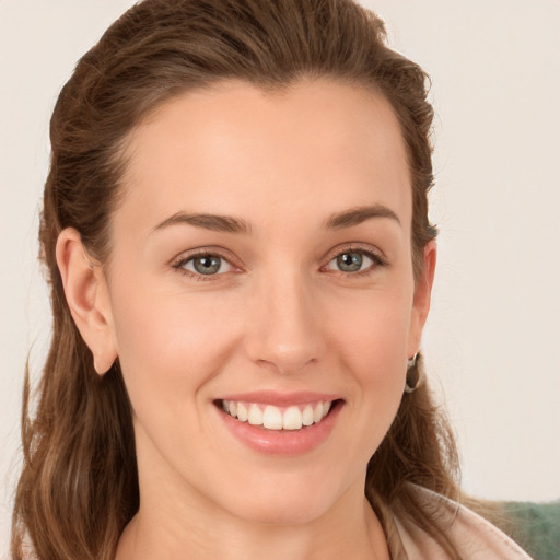 Joyful white young-adult female with long  brown hair and grey eyes