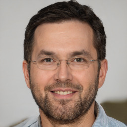 Joyful white adult male with short  brown hair and brown eyes