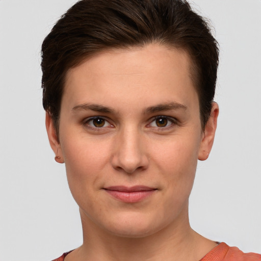 Joyful white young-adult female with short  brown hair and grey eyes