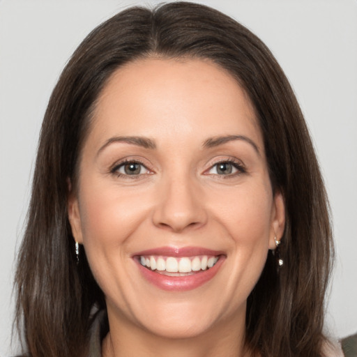 Joyful white adult female with medium  brown hair and brown eyes