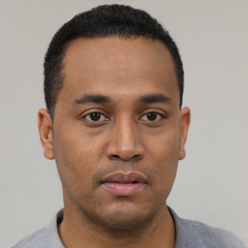 Neutral black young-adult male with short  black hair and brown eyes