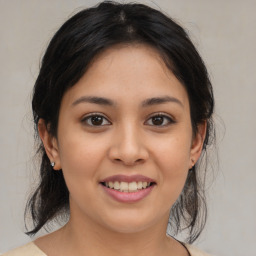 Joyful latino young-adult female with medium  brown hair and brown eyes