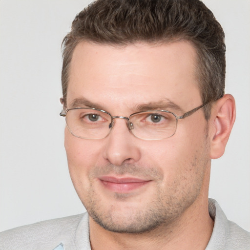 Joyful white adult male with short  brown hair and brown eyes