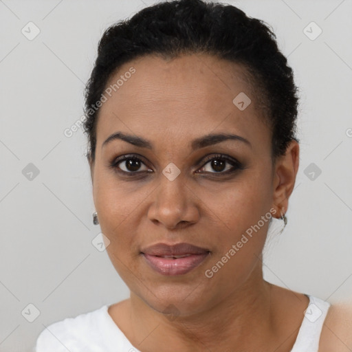 Joyful black young-adult female with short  black hair and brown eyes