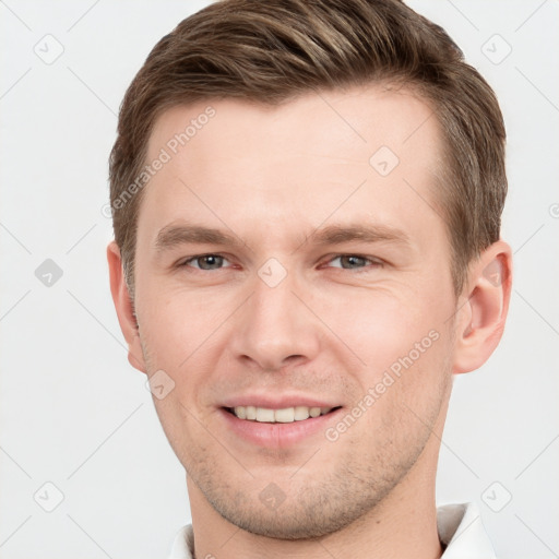 Joyful white young-adult male with short  brown hair and grey eyes