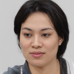 Joyful asian young-adult female with medium  black hair and brown eyes