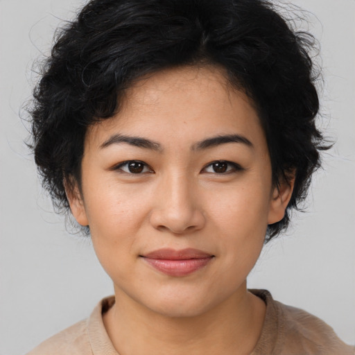 Joyful asian young-adult female with medium  black hair and brown eyes
