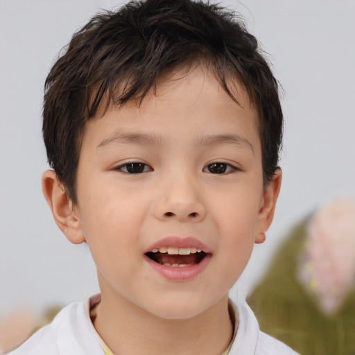 Joyful asian child male with short  brown hair and brown eyes