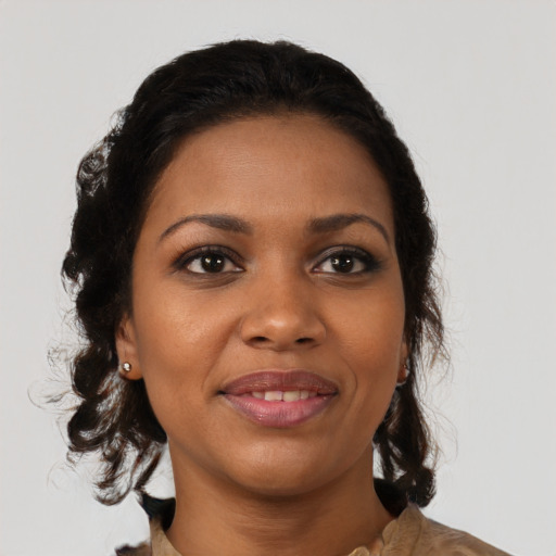 Joyful black young-adult female with medium  brown hair and brown eyes