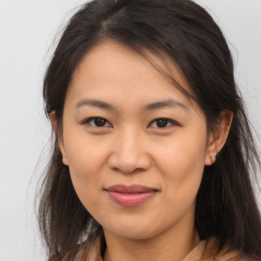 Joyful asian young-adult female with long  brown hair and brown eyes