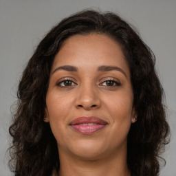 Joyful latino young-adult female with long  brown hair and brown eyes