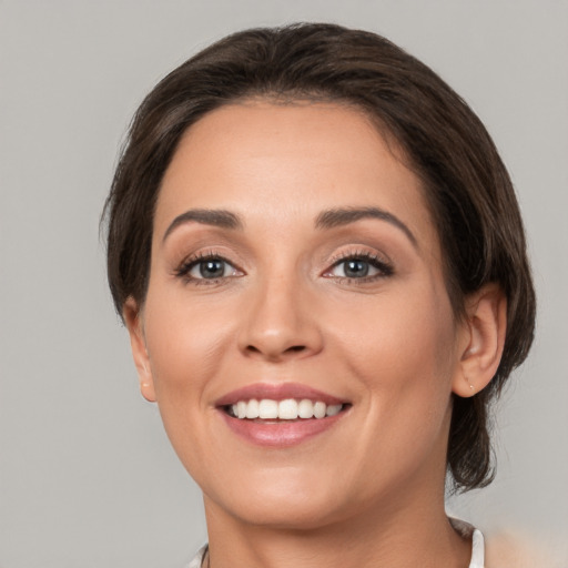 Joyful white young-adult female with medium  brown hair and brown eyes