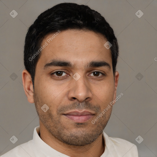 Joyful latino young-adult male with short  black hair and brown eyes