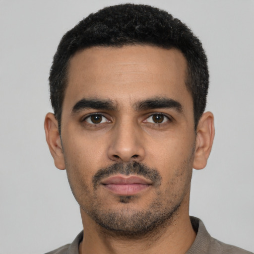 Neutral latino young-adult male with short  black hair and brown eyes