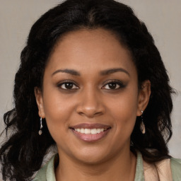 Joyful black young-adult female with long  brown hair and brown eyes