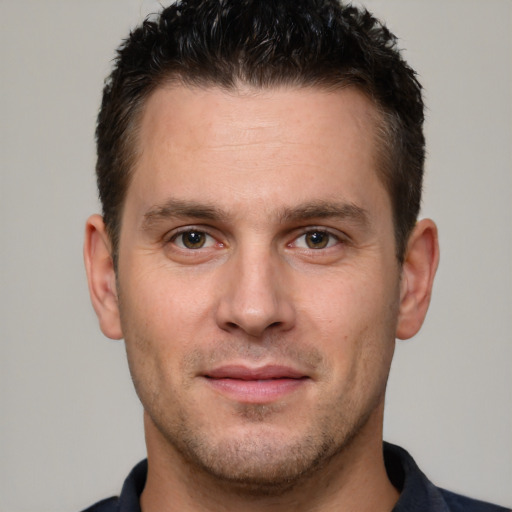 Joyful white young-adult male with short  brown hair and brown eyes