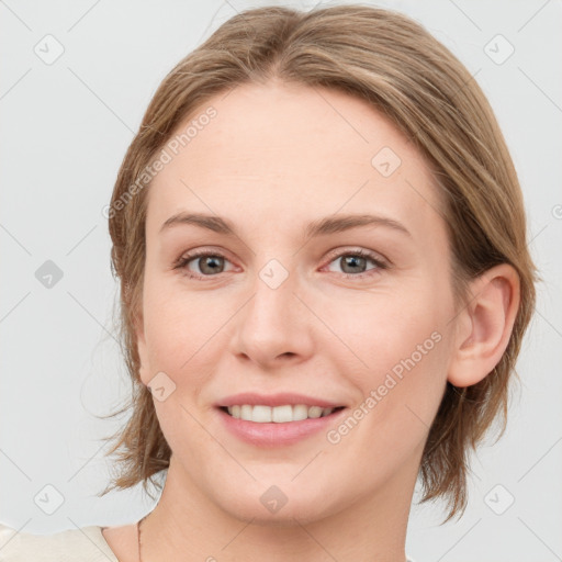 Joyful white young-adult female with medium  brown hair and blue eyes