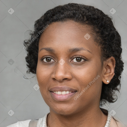 Joyful black young-adult female with short  brown hair and brown eyes