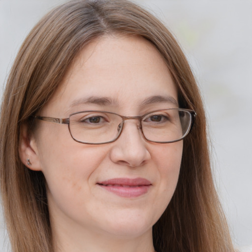 Joyful white adult female with long  brown hair and brown eyes