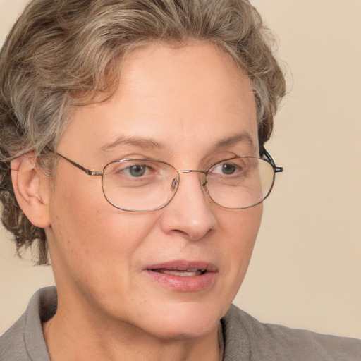 Joyful white middle-aged female with short  brown hair and brown eyes