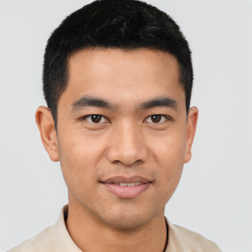 Joyful asian young-adult male with short  black hair and brown eyes