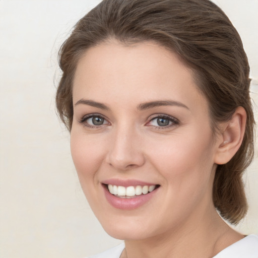 Joyful white young-adult female with medium  brown hair and green eyes