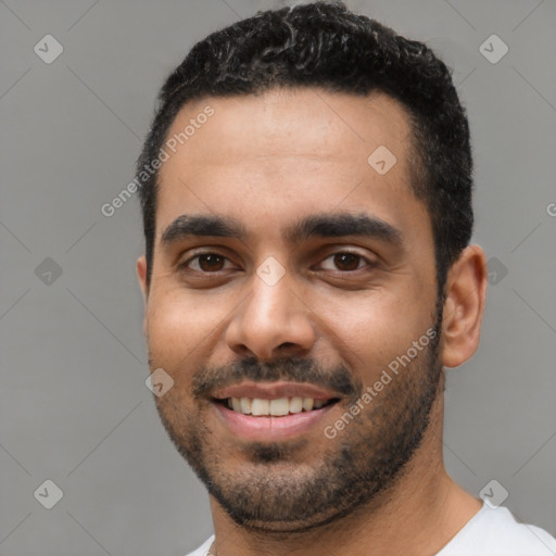 Joyful latino young-adult male with short  black hair and brown eyes