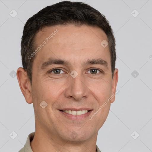 Joyful white adult male with short  brown hair and brown eyes