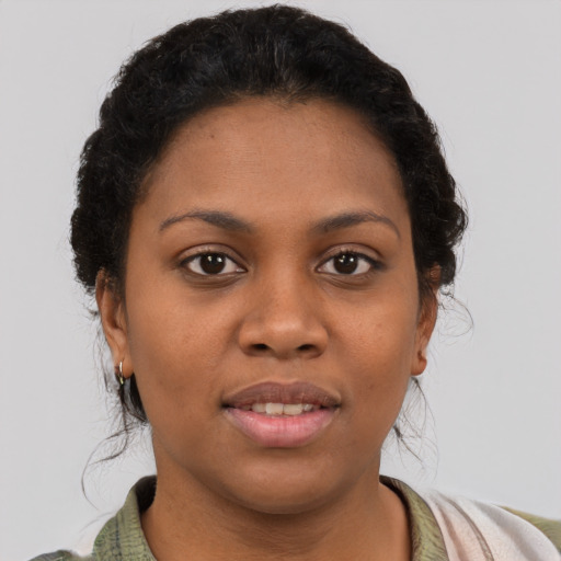 Joyful black young-adult female with short  brown hair and brown eyes