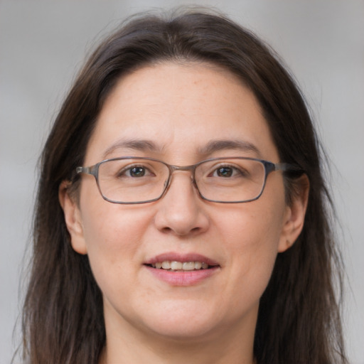 Joyful white adult female with medium  brown hair and brown eyes