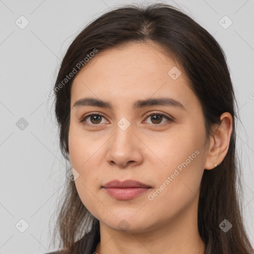 Joyful white young-adult female with long  brown hair and brown eyes