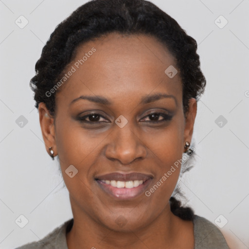 Joyful black adult female with short  black hair and brown eyes
