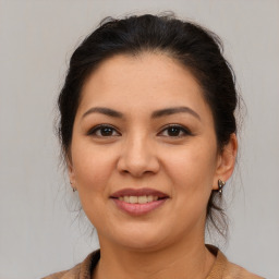 Joyful latino young-adult female with medium  brown hair and brown eyes