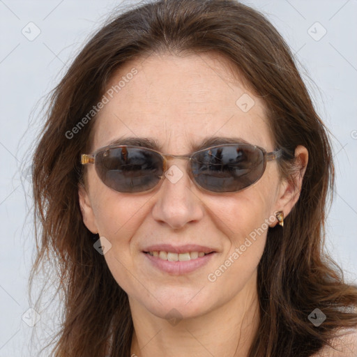 Joyful white adult female with long  brown hair and brown eyes