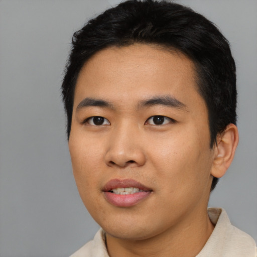 Joyful asian young-adult male with short  black hair and brown eyes