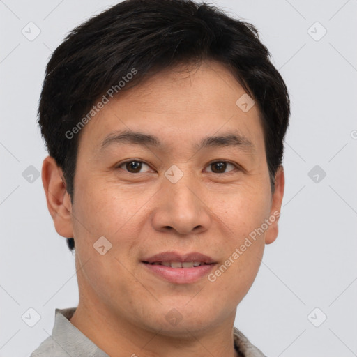 Joyful asian young-adult male with short  brown hair and brown eyes