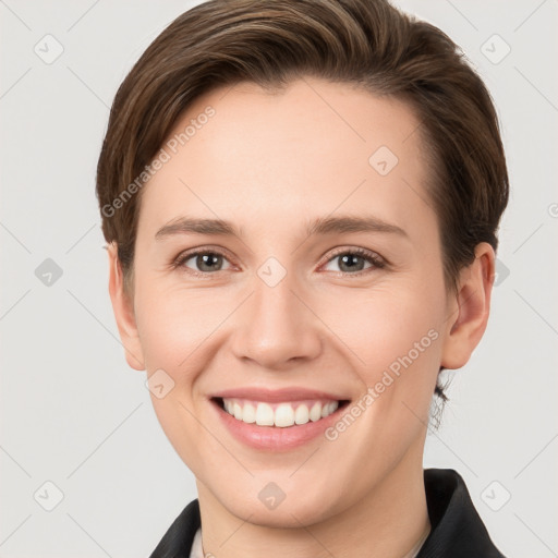 Joyful white young-adult female with short  brown hair and grey eyes