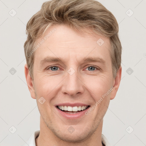 Joyful white adult male with short  brown hair and grey eyes