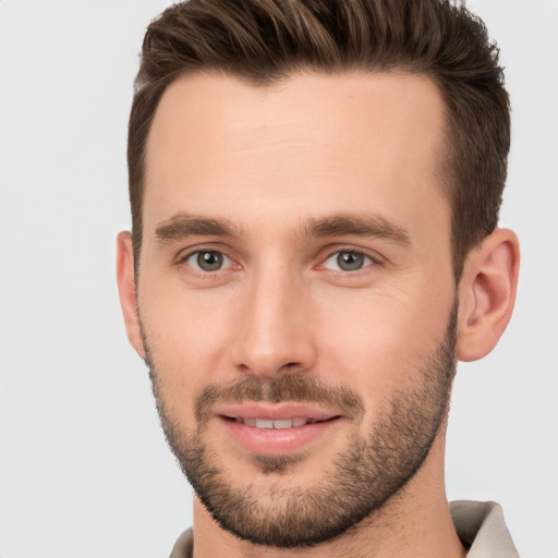 Joyful white young-adult male with short  brown hair and brown eyes