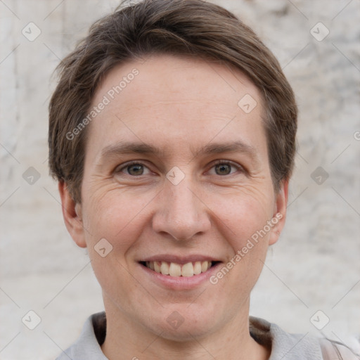 Joyful white adult male with short  brown hair and grey eyes