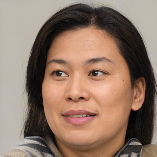 Joyful asian adult female with medium  brown hair and brown eyes