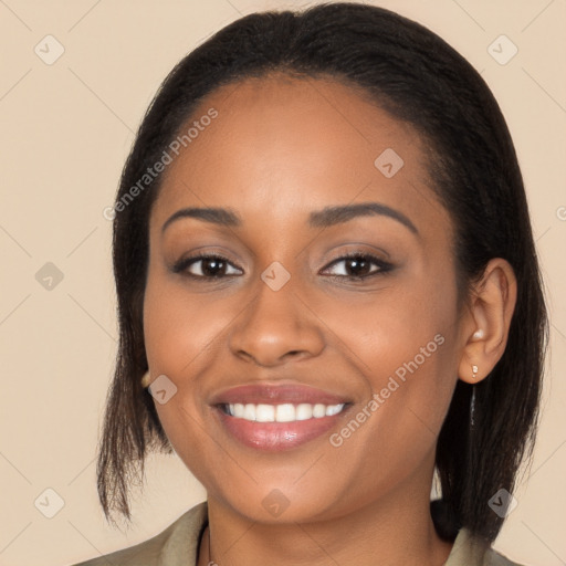 Joyful black young-adult female with long  brown hair and brown eyes